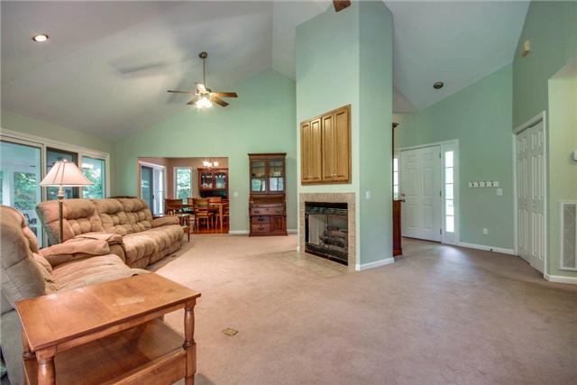 7378 Walker Road Fairview, TN 37062 - Photo 4 of 20 Another view of the entry way and living room with fireplace.