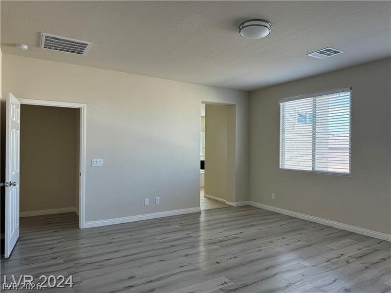 9056 Tony Ridge Avenue Las Vegas, NV 89148 - Photo 16 of 32 A versatile interior space featuring modern flooring and ample natural light, ready for personalization.