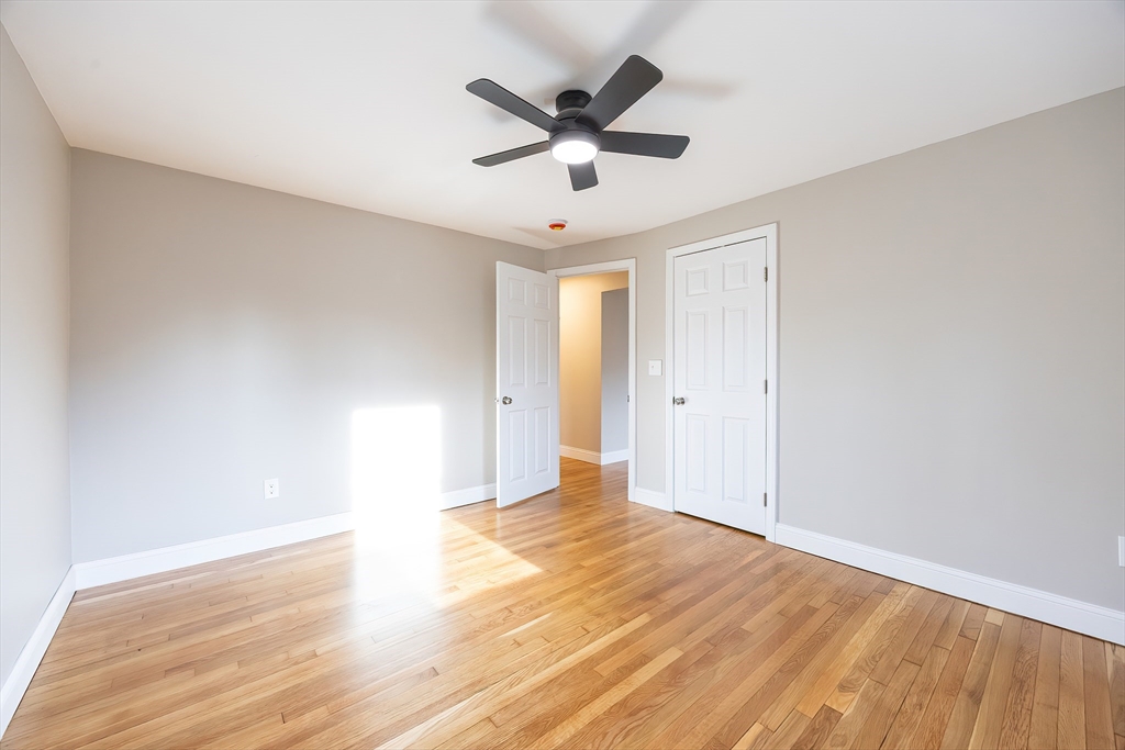 1123 County Street Attleboro, MA 02703 - Photo 11 of 20 an empty room with wooden floor and ceiling fan
