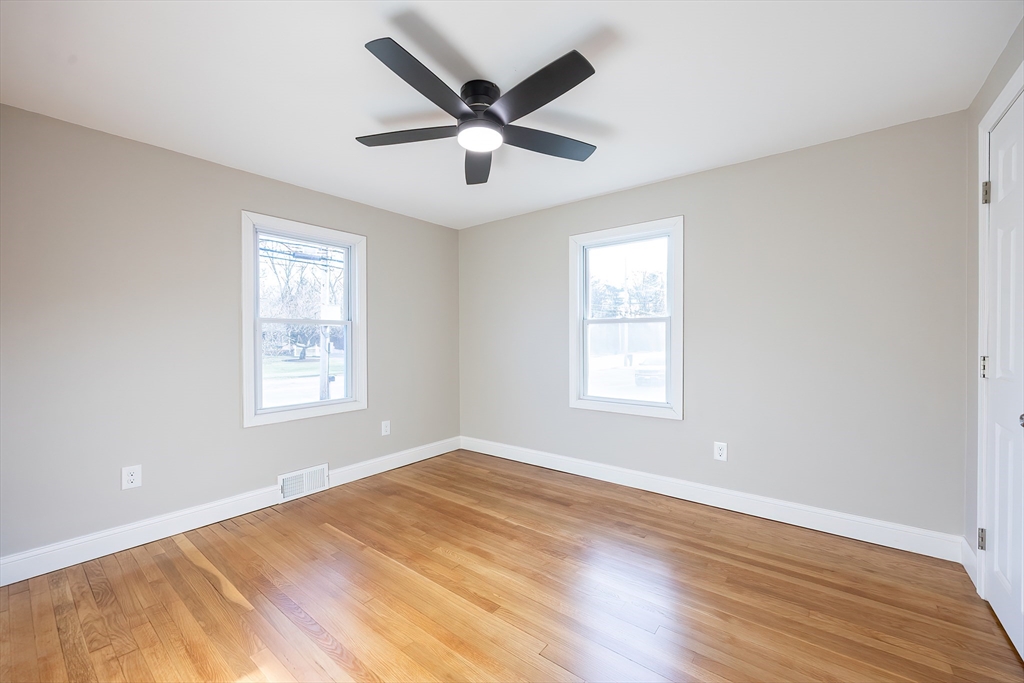 1123 County Street Attleboro, MA 02703 - Photo 12 of 20 a view of an empty room with wooden floor and a window
