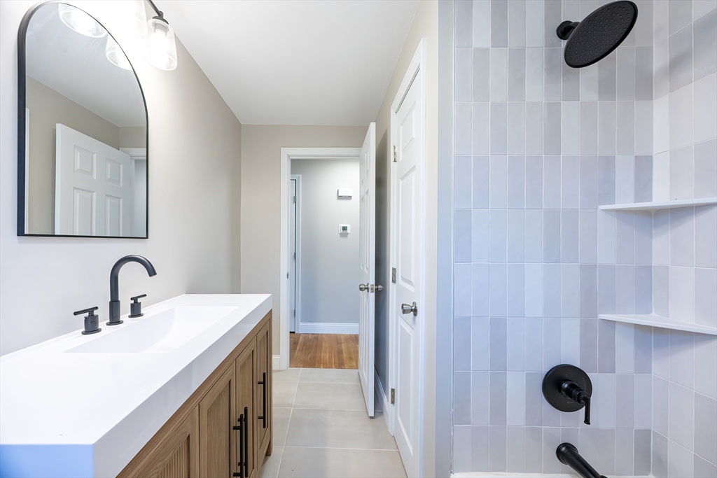 1123 County Street Attleboro, MA 02703 - Photo 9 of 20 a bathroom with a sink and a mirror