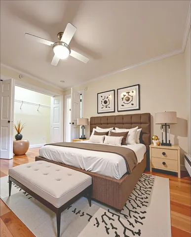 a bedroom with a bed and wooden floor