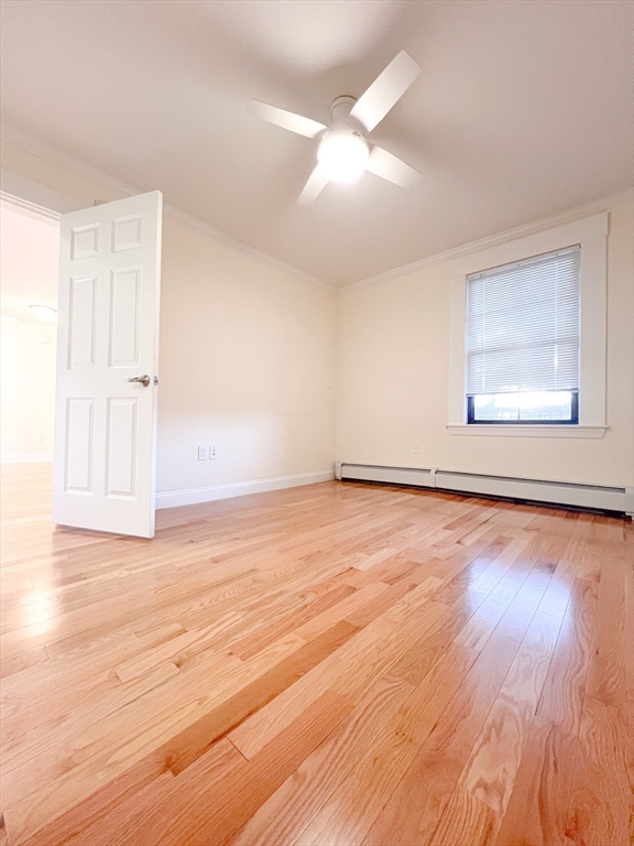 219 Commonwealth Avenue, Unit 21 Newton, MA 02467 - Photo 3 of 9 an empty room with wooden floor and windows