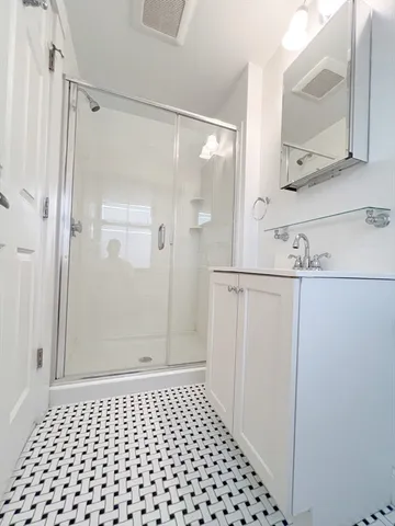a bathroom with a glass door shower