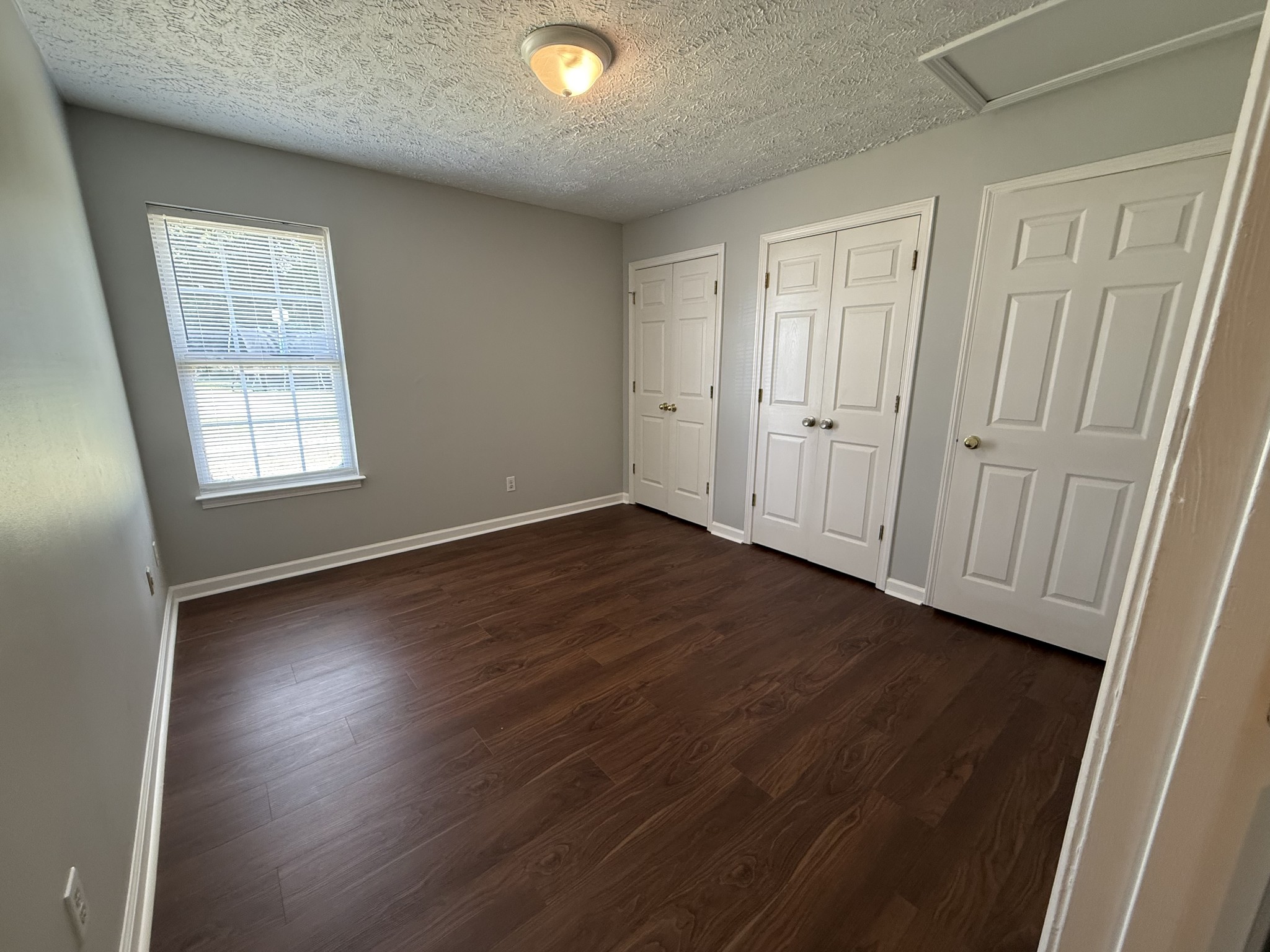 1538 Chariot Drive Murfreesboro, TN 37130 - Photo 5 of 9 an empty room with wooden floor and windows