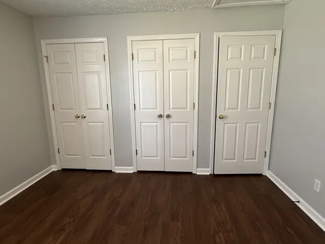 an empty room with wooden floor