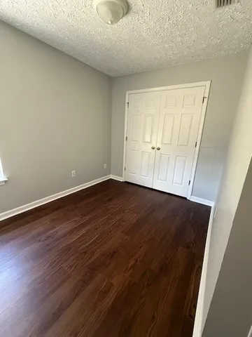 an empty room with wooden floor