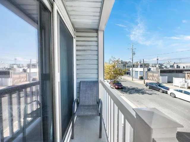 a bedroom with a bed flat screen tv and a window