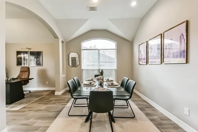 a dining room with furniture windows and a chandelier