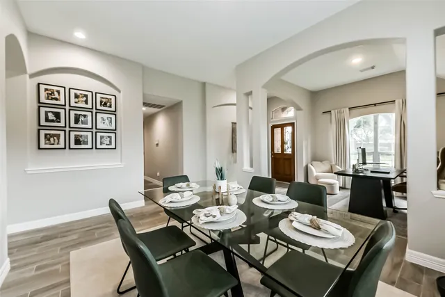 a dining room with furniture a window and wooden floor
