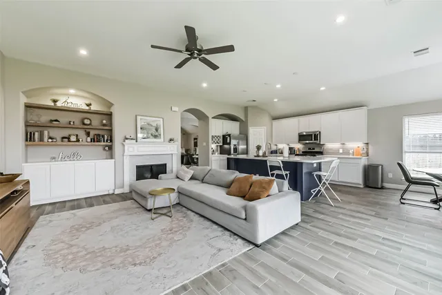 a living room with furniture and kitchen view