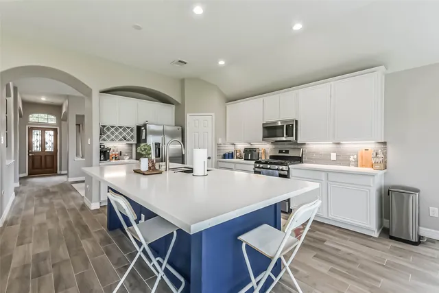 a open kitchen with sink cabinets and wooden floor