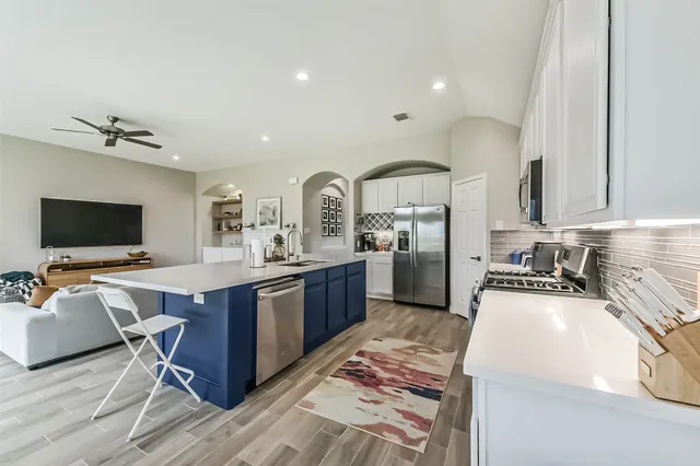 a large kitchen with a table and chairs in it
