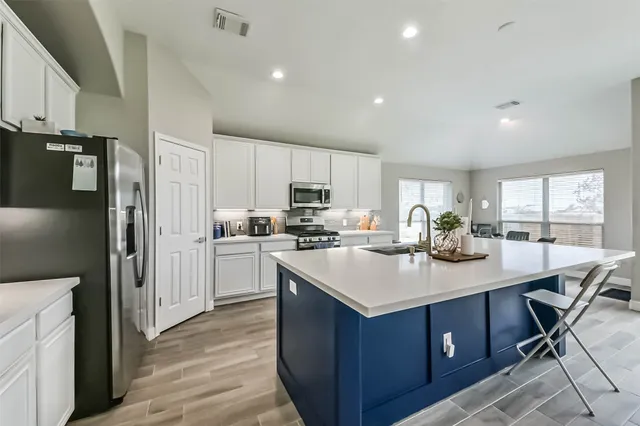 a kitchen with a sink stove and refrigerator