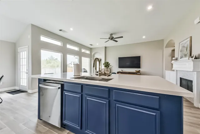 a kitchen with stainless steel appliances a sink and cabinets