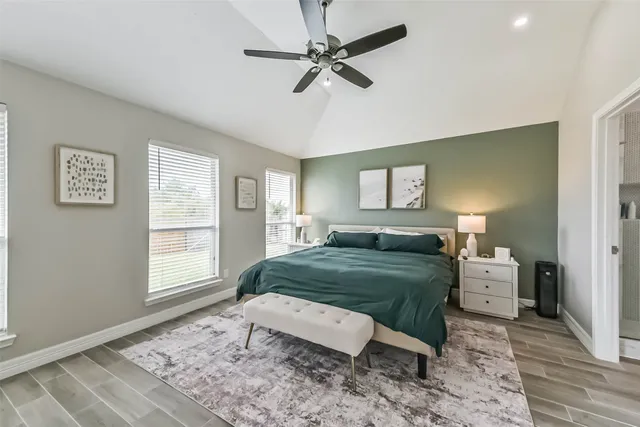 a bedroom with a bed mirror and window