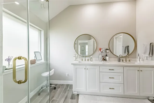 a bathroom with a granite countertop sink a mirror and vanity