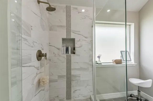 a bathroom with a shower and a sink