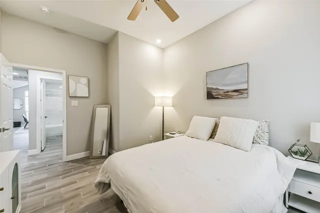 a bedroom with a bed and a painting on the wall