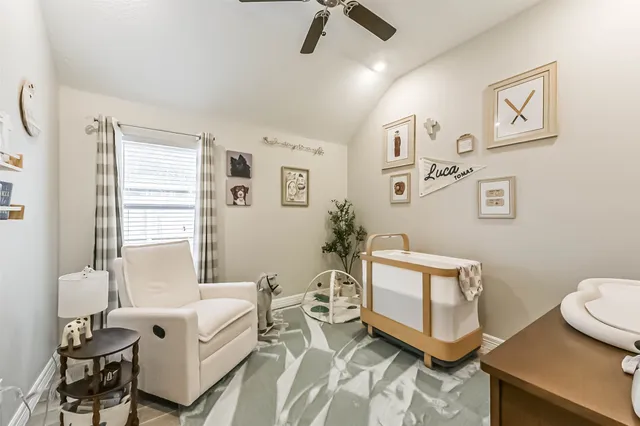 a spacious bedroom with a bed a couch and a window