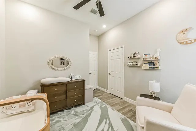 a bedroom with a bed and ceiling fan