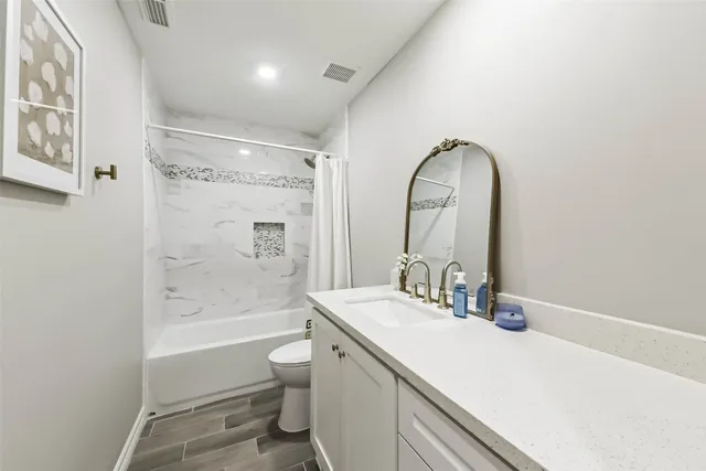 a bathroom with a sink a toilet and a bathtub