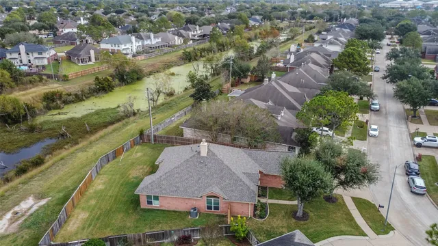an aerial view of residential houses with outdoor space
