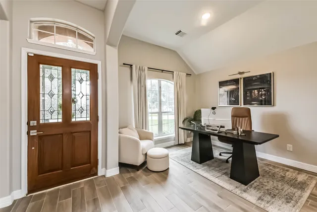 a living room with furniture and a wooden floor