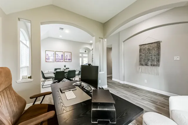 a view of a workspace with furniture and a window