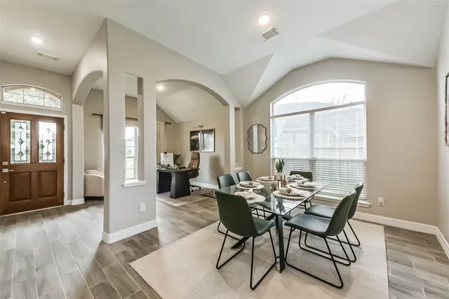 a view of a dining room with furniture and wooden floor