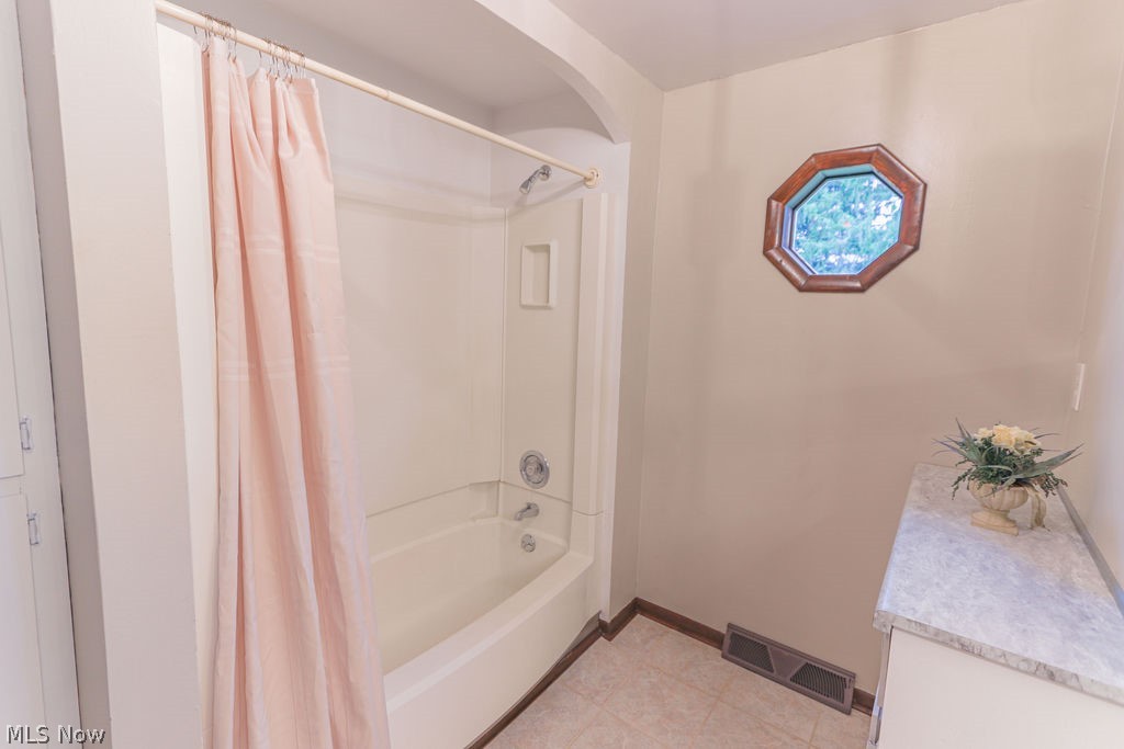 51883 Telegraph Road Amherst, OH 44001 - Photo 26 of 49 Bathroom featuring vanity and shower / bathtub combination with curtain