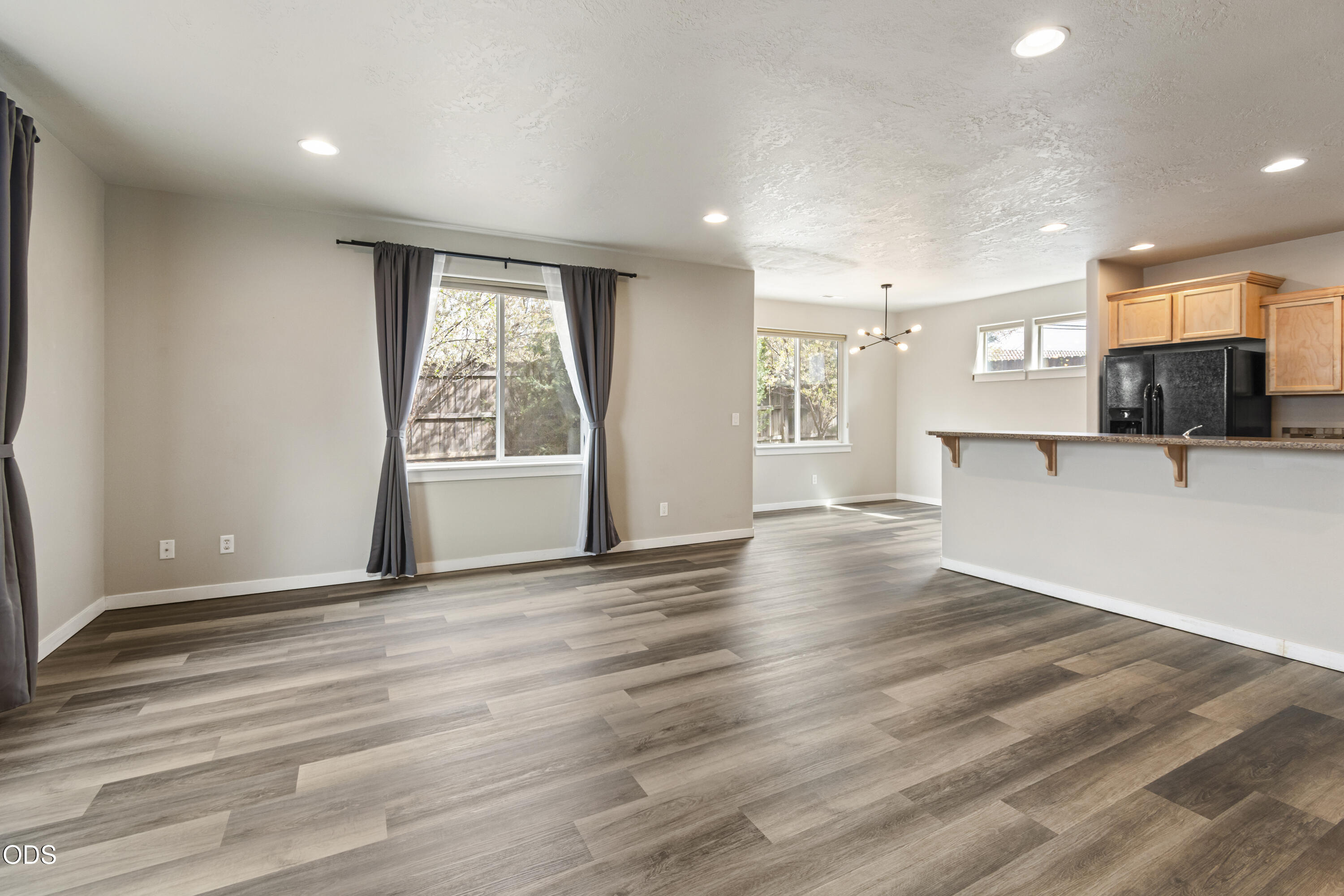 21332 Oconnor Way Bend, OR 97701 - Photo 16 of 33 an empty room with wooden floor and a window