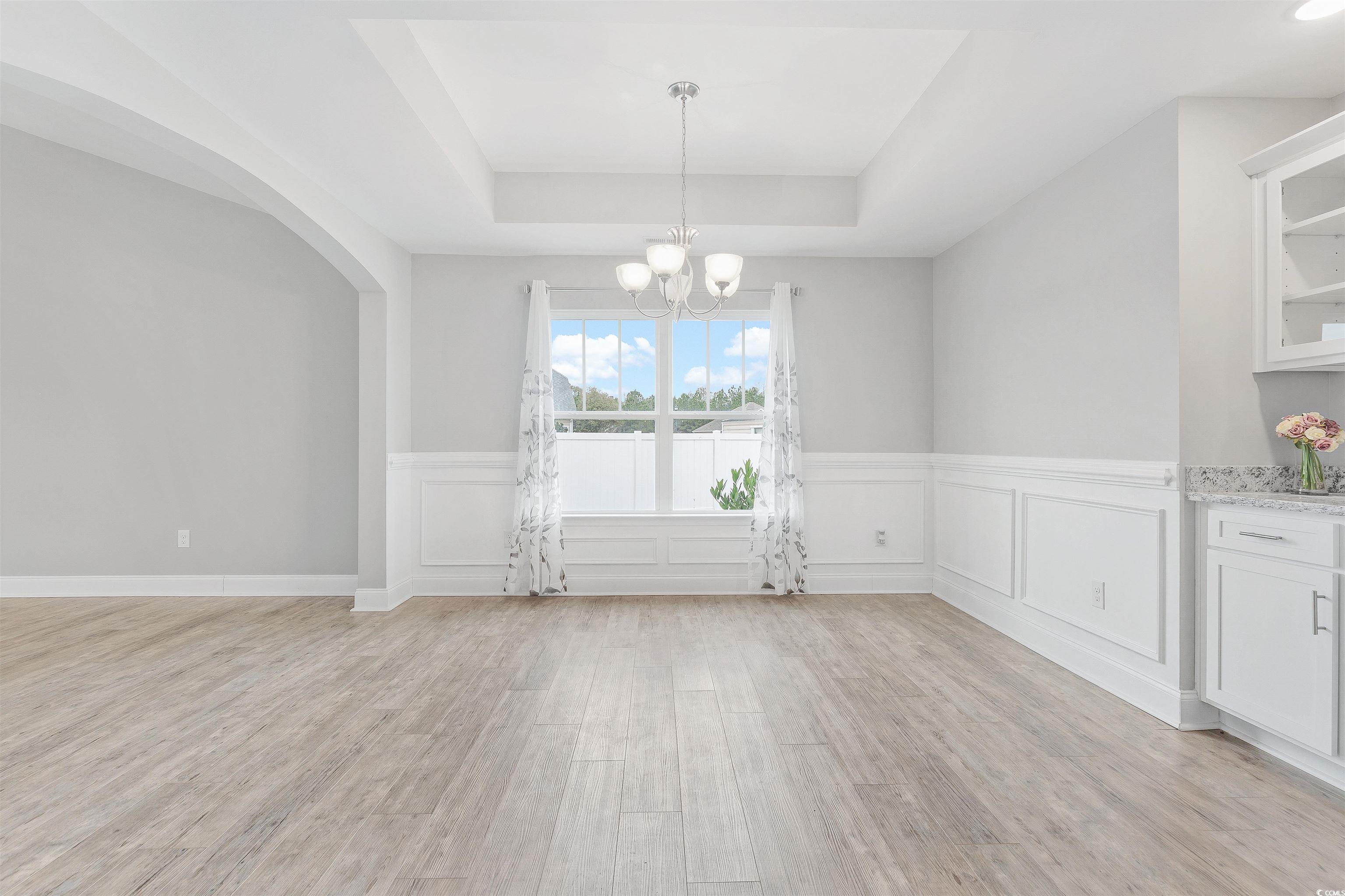 317 Marsh Tacky Loop Myrtle Beach, SC 29588 - Photo 11 of 29 Unfurnished dining area featuring light hardwood /