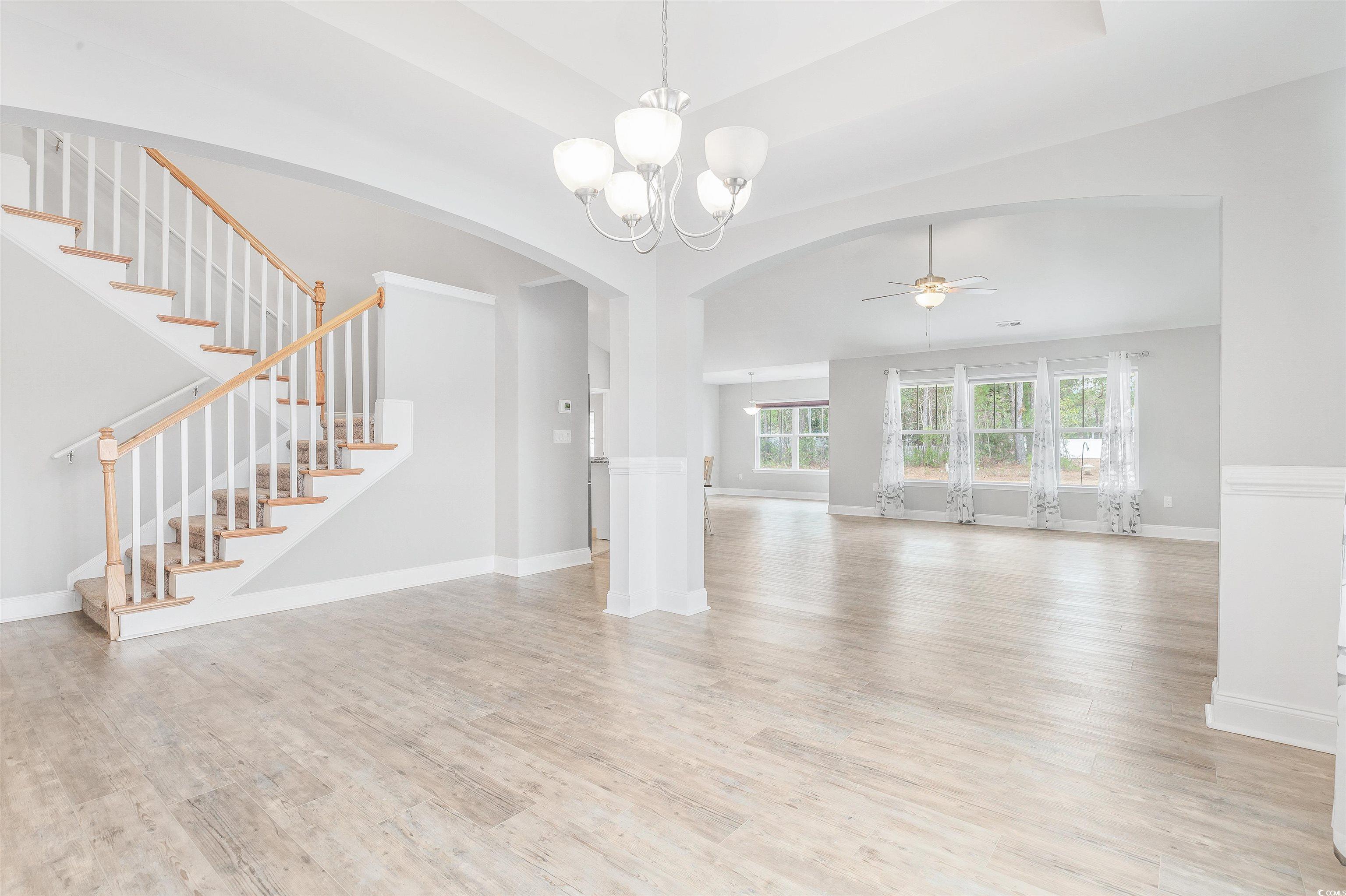 317 Marsh Tacky Loop Myrtle Beach, SC 29588 - Photo 18 of 29 Unfurnished living room featuring ceiling fan with
