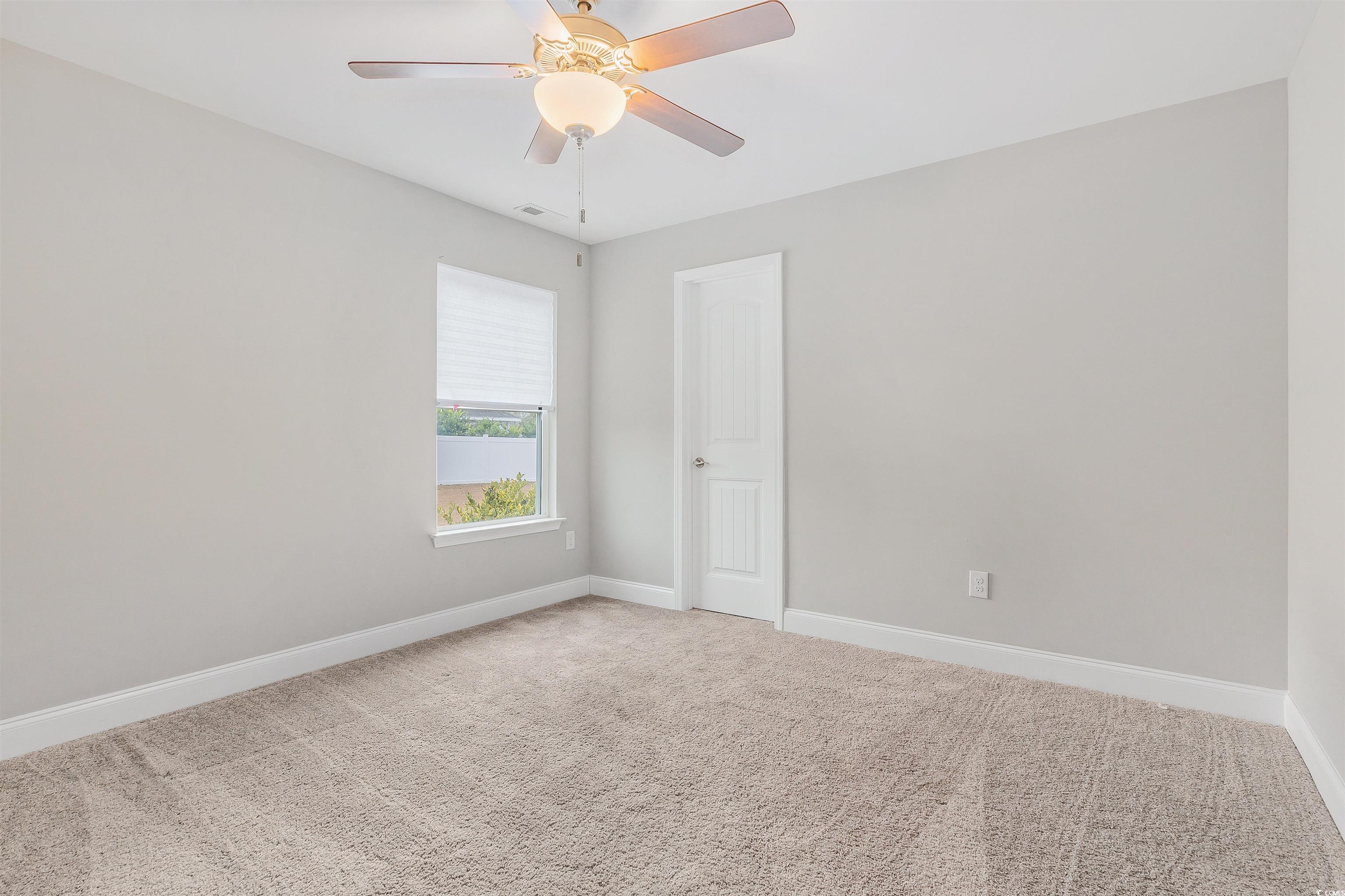 317 Marsh Tacky Loop Myrtle Beach, SC 29588 - Photo 23 of 29 Carpeted spare room featuring ceiling fan