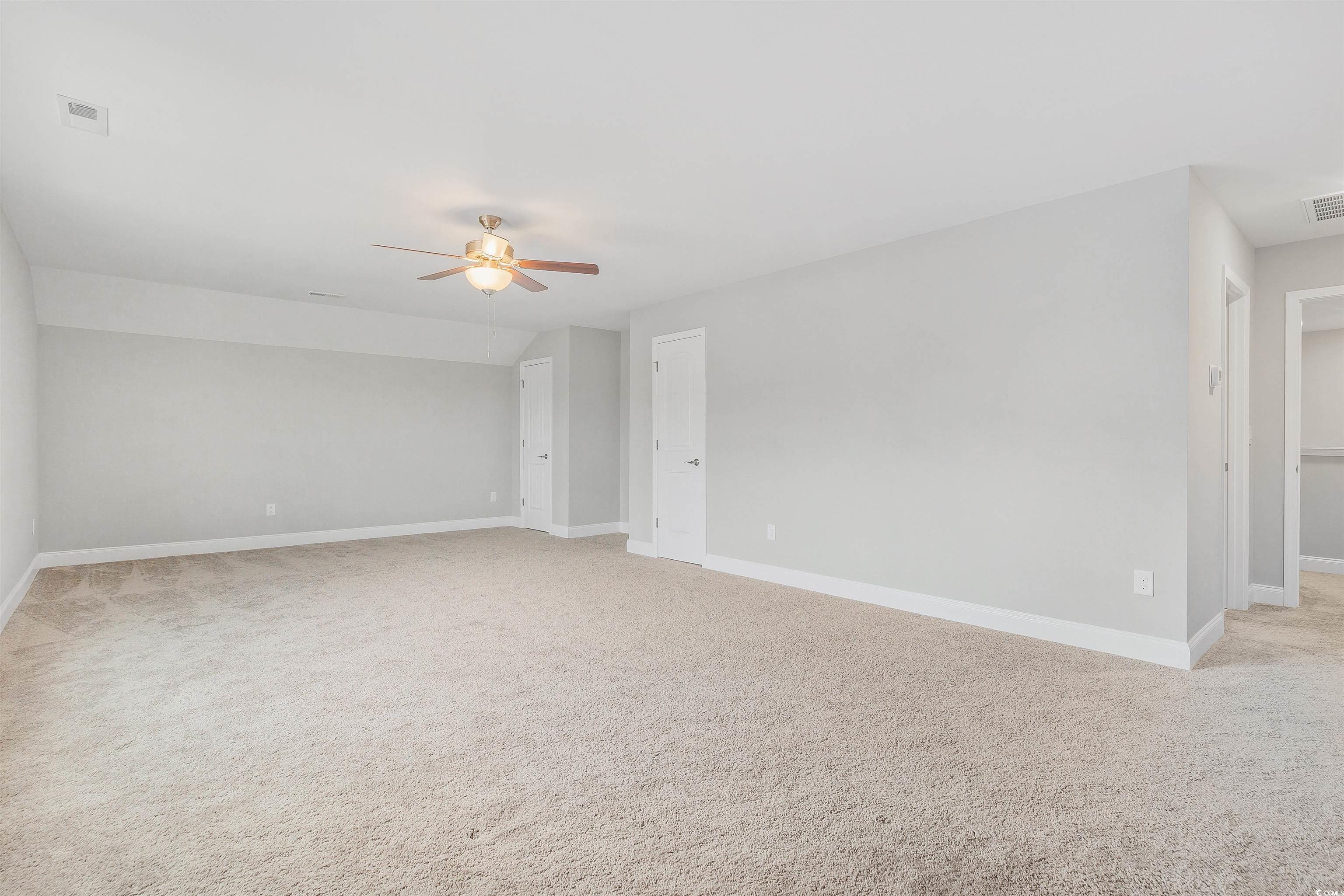 317 Marsh Tacky Loop Myrtle Beach, SC 29588 - Photo 25 of 29 Empty room featuring light colored carpet, vaulted
