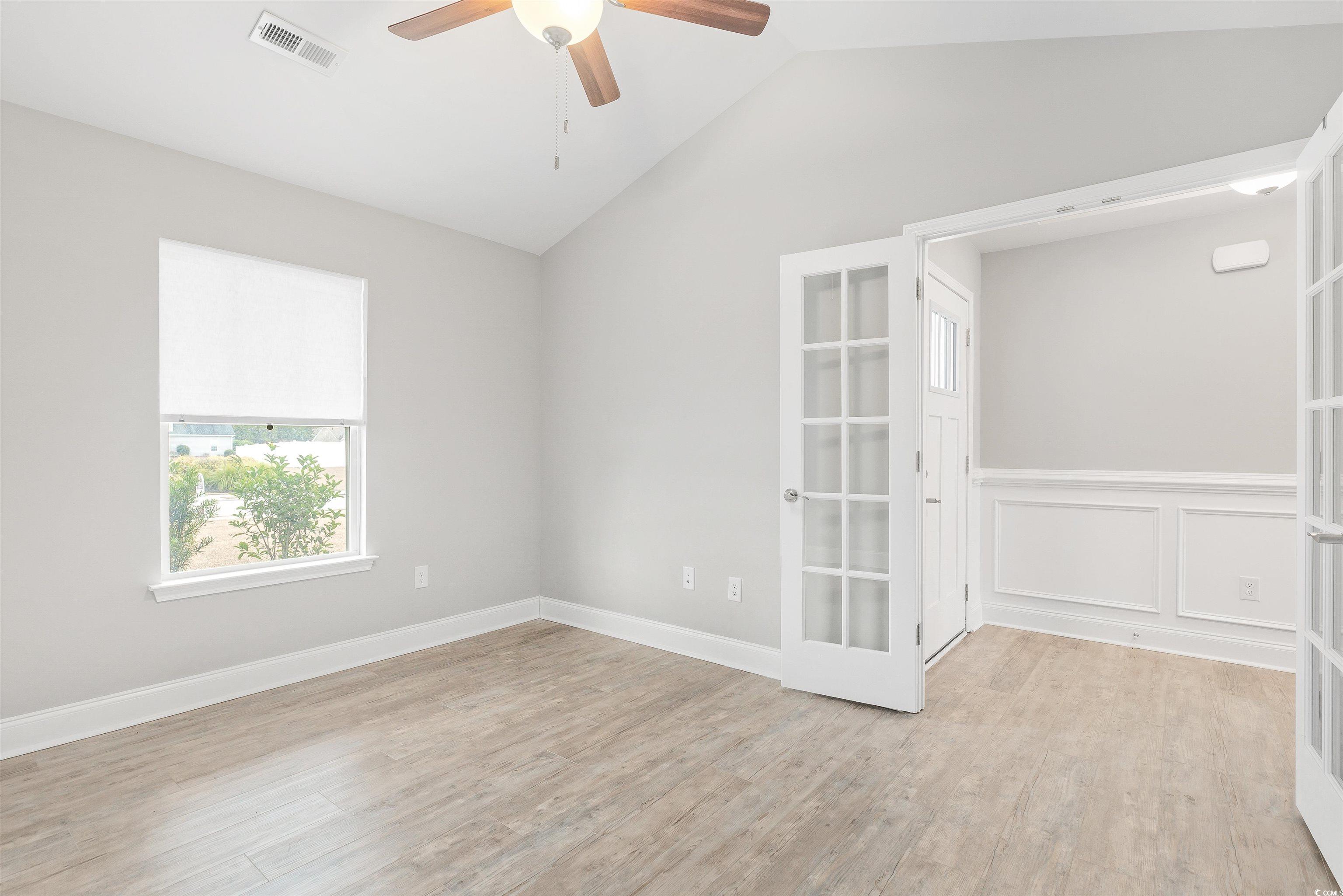 317 Marsh Tacky Loop Myrtle Beach, SC 29588 - Photo 3 of 29 Unfurnished room with ceiling fan, light hardwood