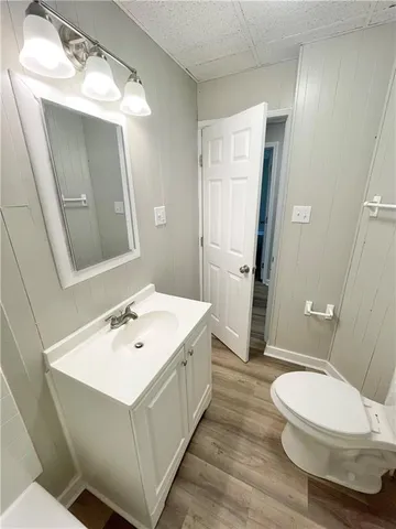 a bathroom with a sink a toilet and mirror
