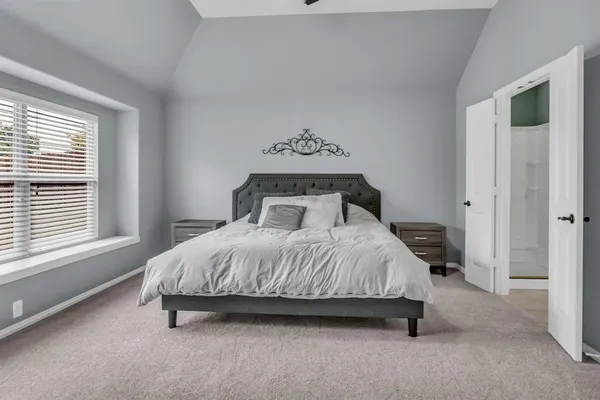 a bedroom with a bed and window