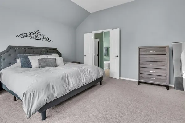 a bedroom with a bed and a mirror