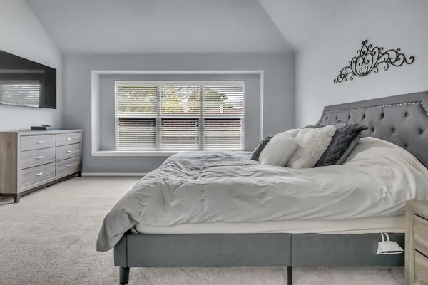 a large white bed in a white bedroom