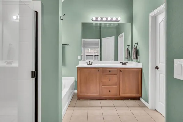 a bathroom with a double vanity sink and a mirror