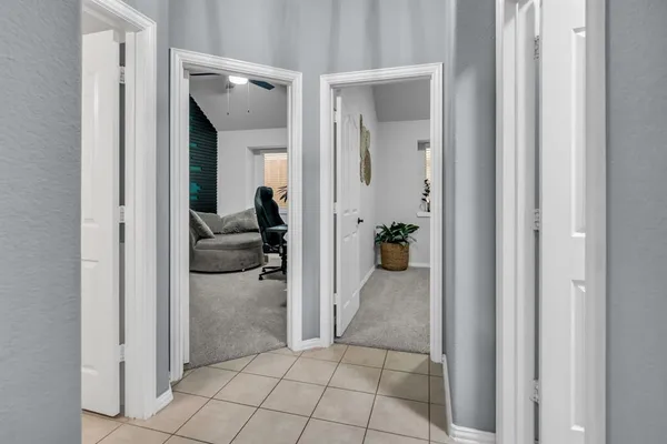 a view of a hallway view with three rooms