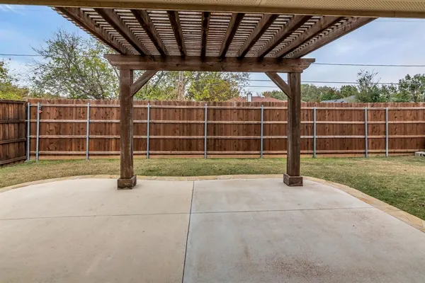 a view of a backyard with a fence