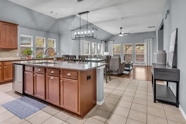 a kitchen with stainless steel appliances granite countertop a stove and cabinets
