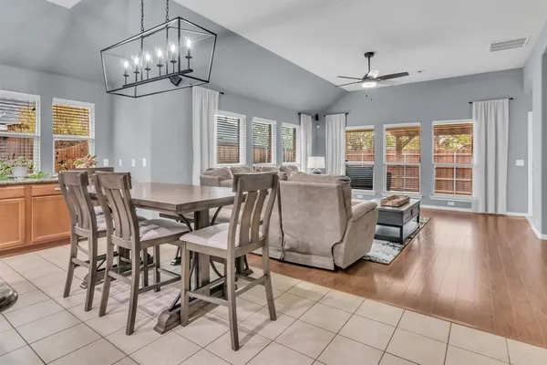 a view of a dining room with furniture wooden floor and chandelier
