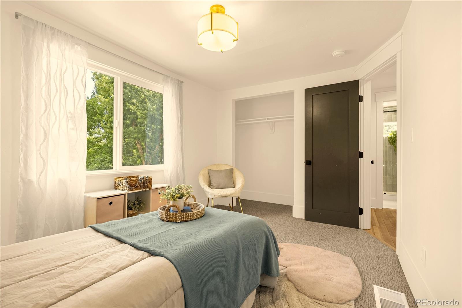 200 West Cheyenne Road Colorado Springs, CO 80906 - Photo 20 of 24 a bedroom with a bed and large window with chair