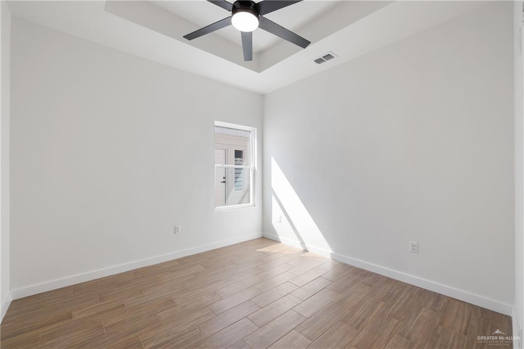 2900 Gabriel Street, Unit 4 Mission, TX 78574 - Photo 6 of 14 wooden floor in an empty room with a window