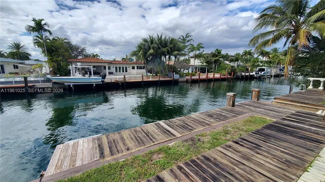 a view of a lake with houses in the background