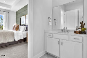 1111 Masters Place Way Durham, NC 27703 - Photo 12 of 37 a en suite bathroom with a sink and a mirror